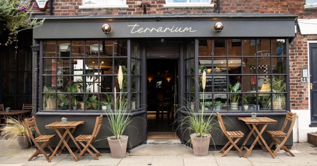 Award-winning restaurant Terrarium in Tarporley (Image: Caroline White Photography). Pictured is the beautiful grey storefront with al fresco dining tables out front.
