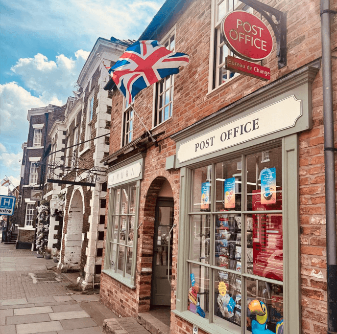 Image of Tarporley High Street. Pictured is the Post Office, Anuka Home Store and award winning pub The Swan. The tradditional 18th and 19th centure architecture can be seen.